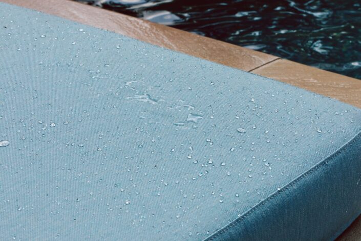 Water droplets on blue couch. Running Under the Sprinkler product photography