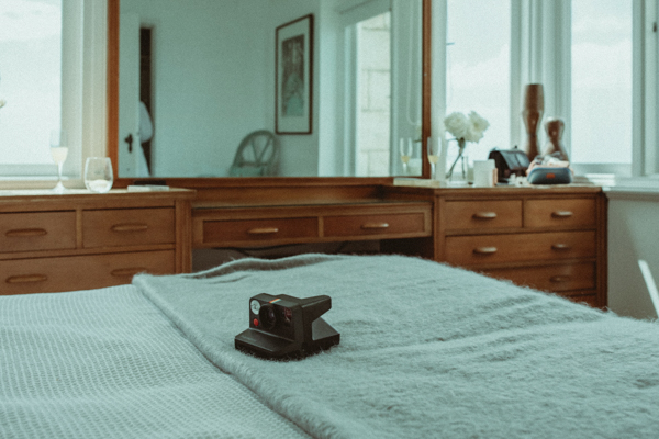 Polaroid camera sitting on a bed