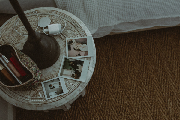 Polaroid photos on bedside table